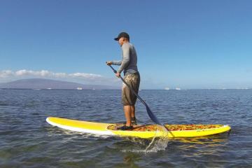 man on stand up paddle board