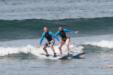 couple surfing lesson maui